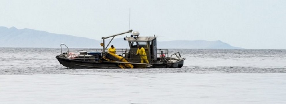Crews recover boom from Refugio Beach Oil Spill.