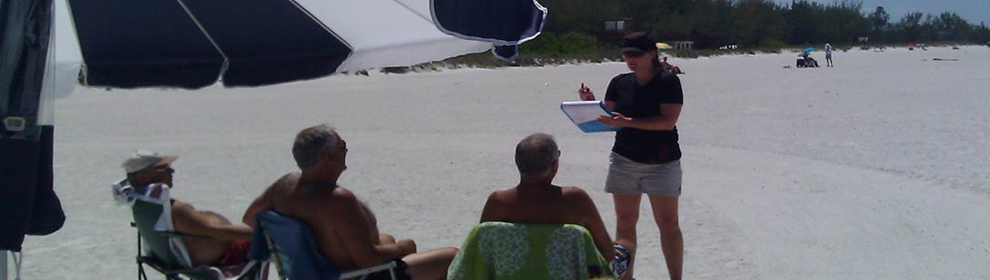 An assessment contractor interviewing beach goers about public recreation losses after the Deepwater Horizon oil spill.