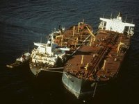 Response crews attempt to remove the remaining oil aboard the grounded tanker Exxon Valdez.