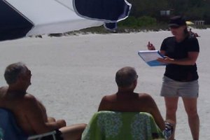 An assessment contractor interviewing beach goers about public recreation losses after the Deepwater Horizon oil spill.